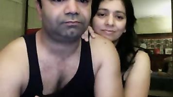 Cute Indian babe sucking her partners cock licking his balls during foreplay while he pumps his dick